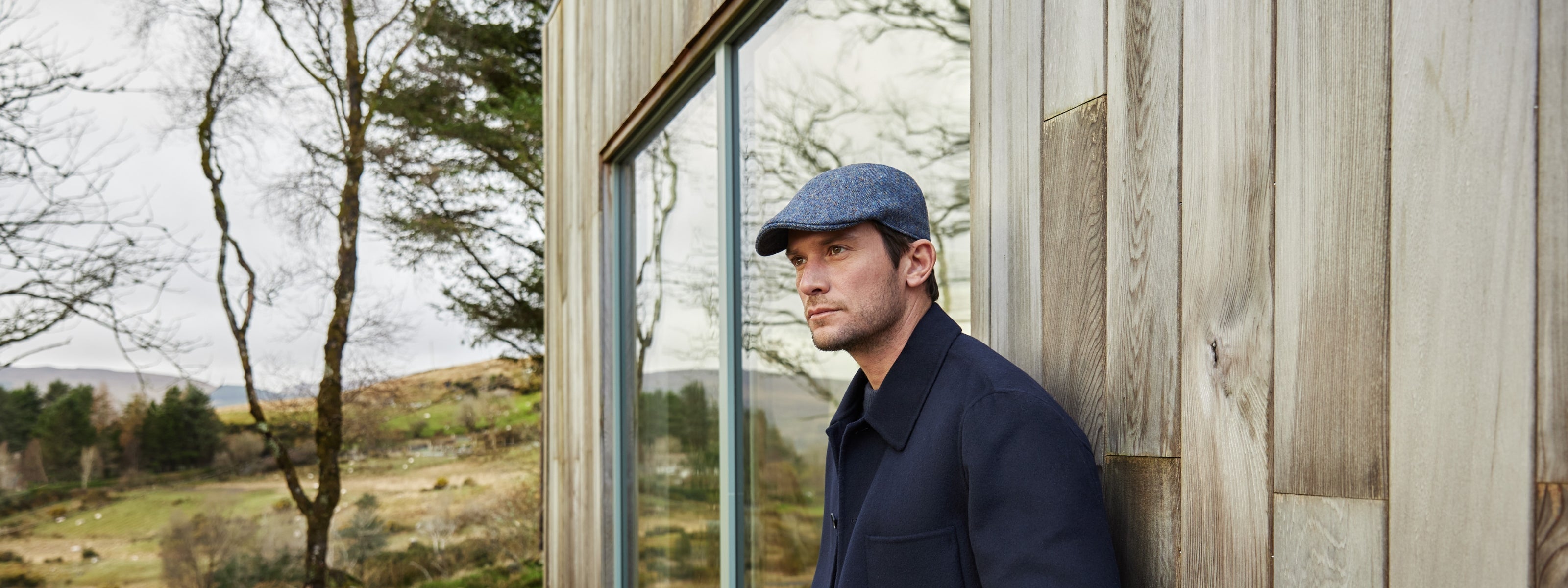 Adam wearing blue tweed duckbill cap with a navy coat.