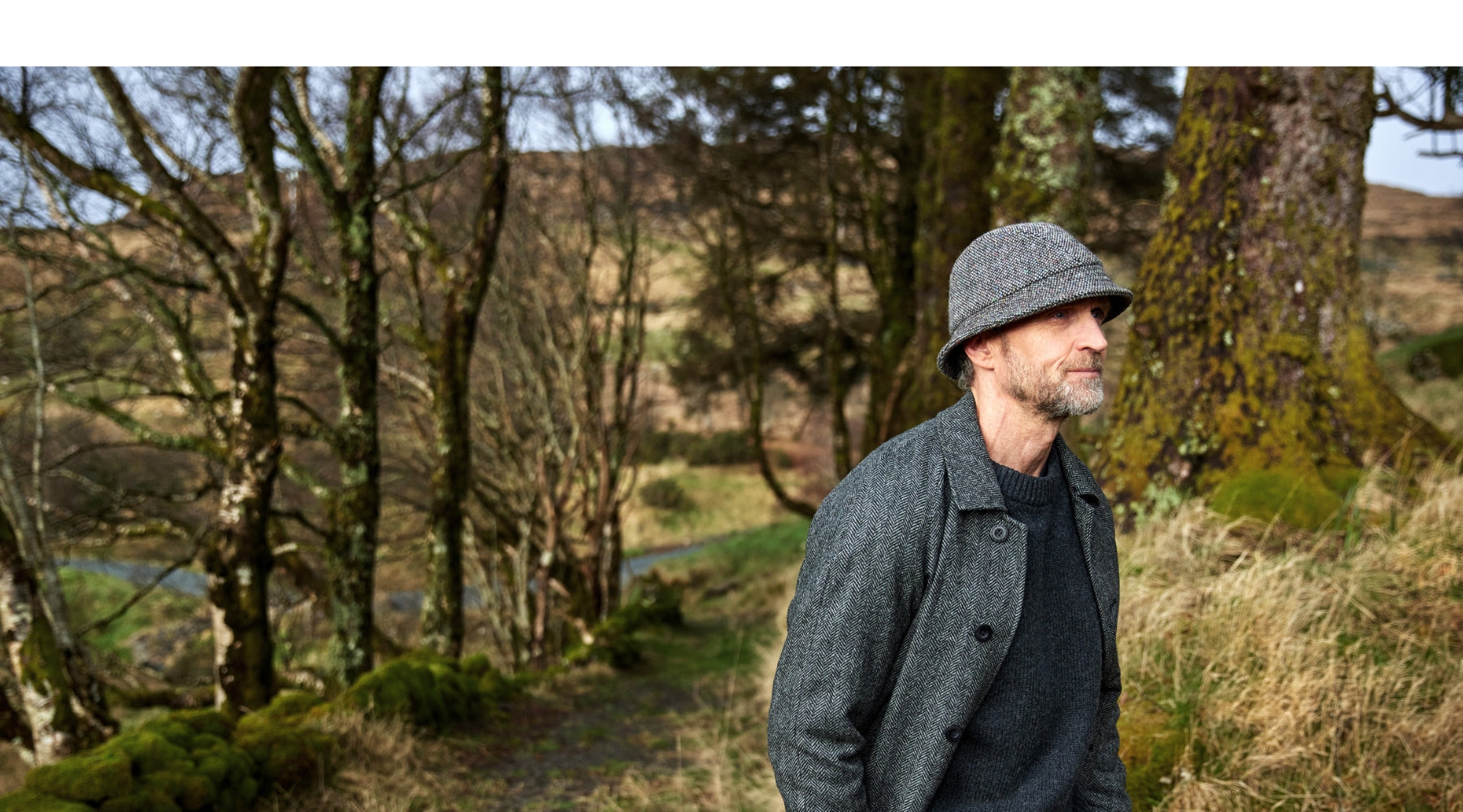 Finn wearing a Irish Tweed Grey Bucket Hat in a forest.
