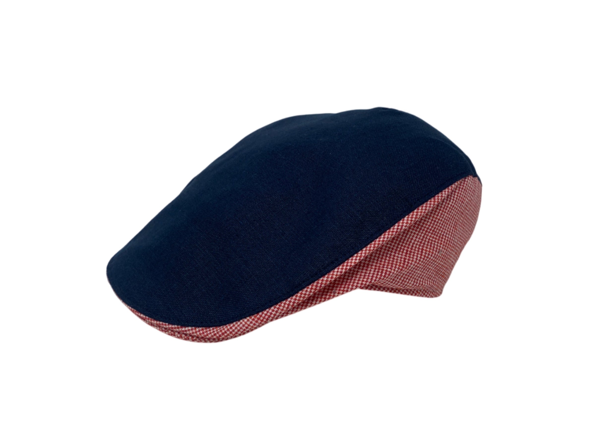 The Donegal Touring Cap Linen 4th of July Limited Edition by Hanna Hats of Donegal Ltd features a navy Irish linen top with bold red-and-white check sides and brim—ideal for festive flair, shown against a crisp white background.