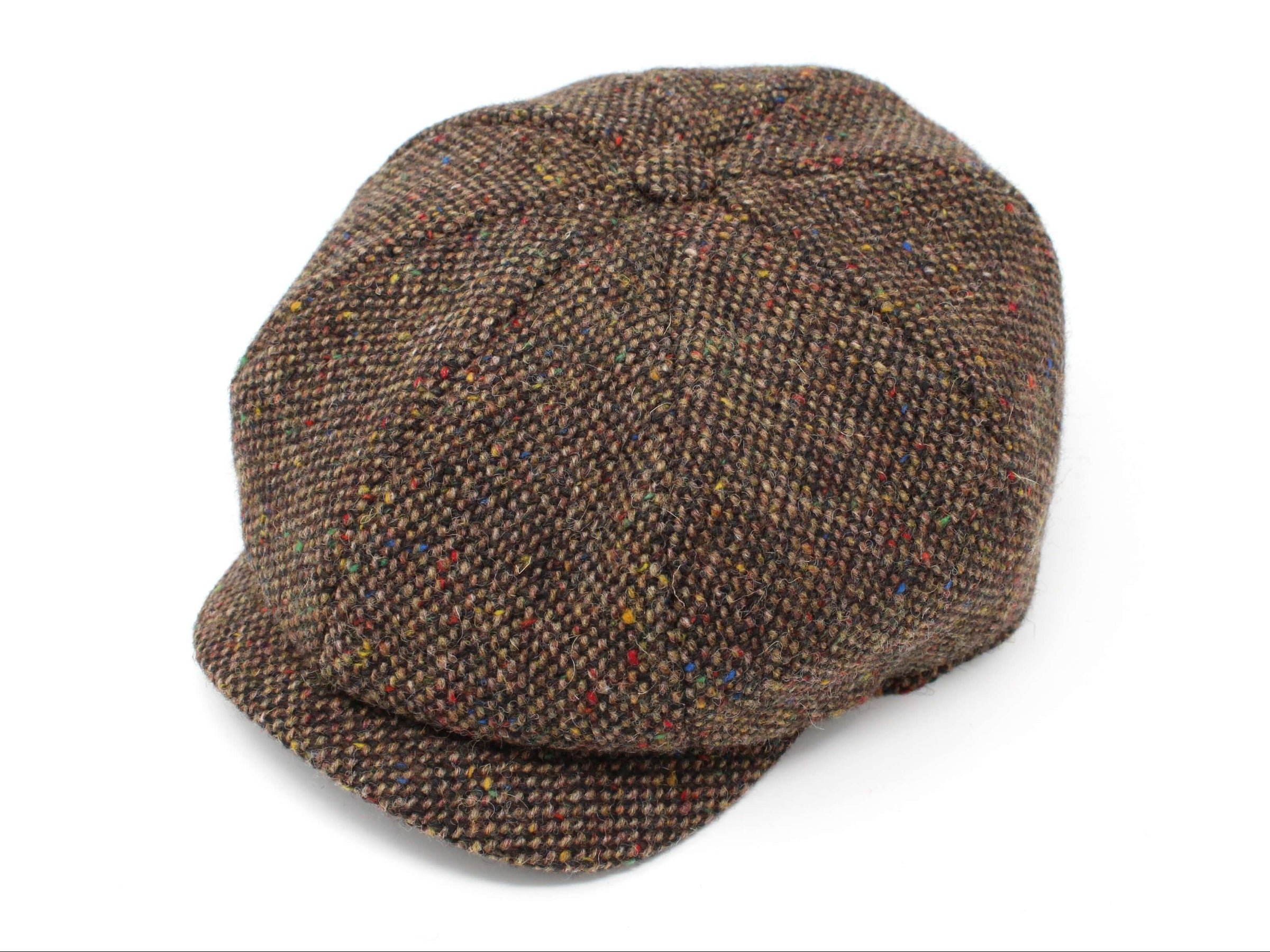 The Hanna Hats JP Cap Tweed is a brown newsboy cap featuring a subtle check pattern and multicolored specks, designed for a perfect fit and displayed on a white background.