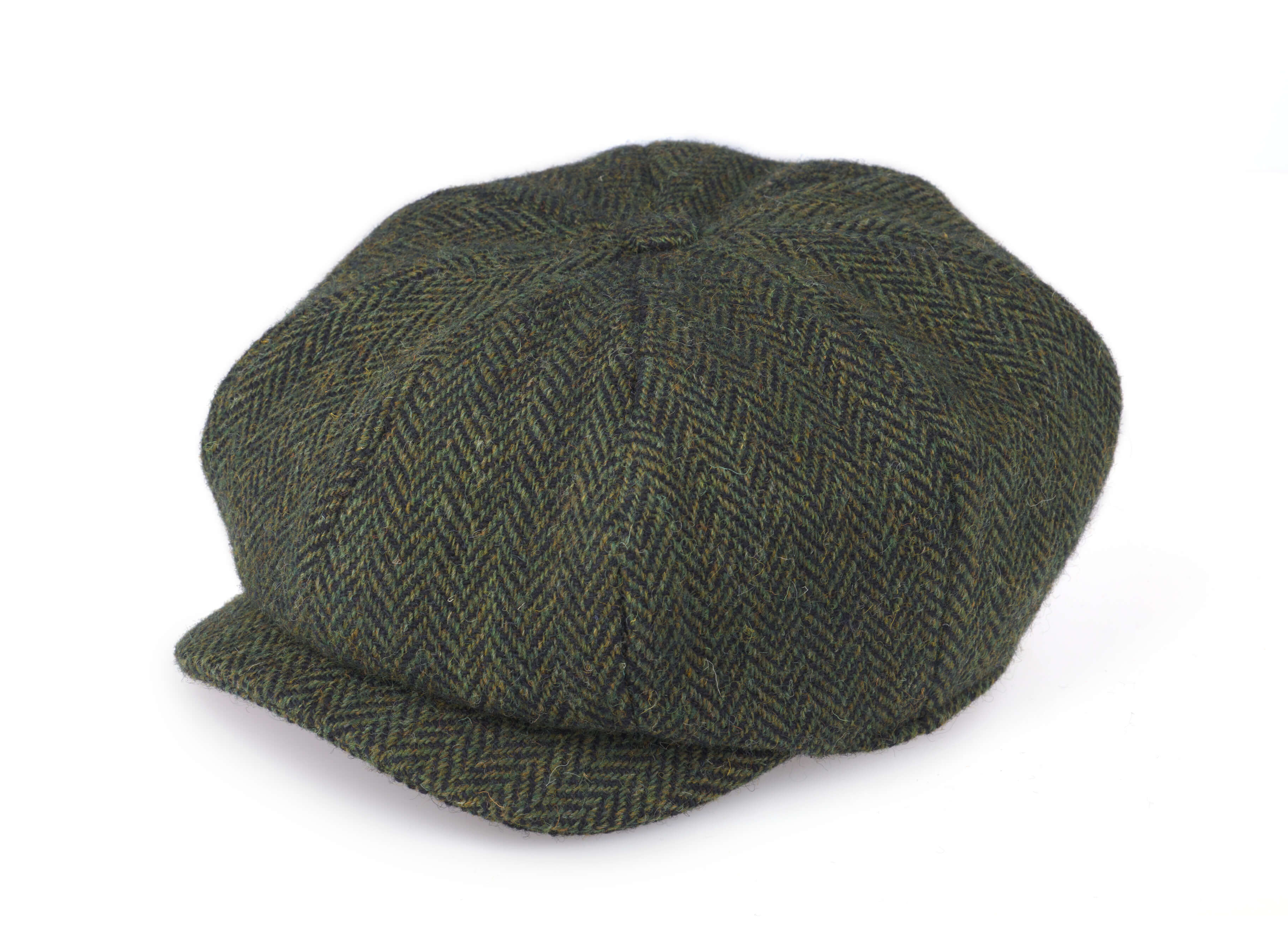 The Hanna Hats JP Cap Tweed is a green and brown herringbone-patterned eight piece flat cap with a short brim and tailored fit, shown on a white background.