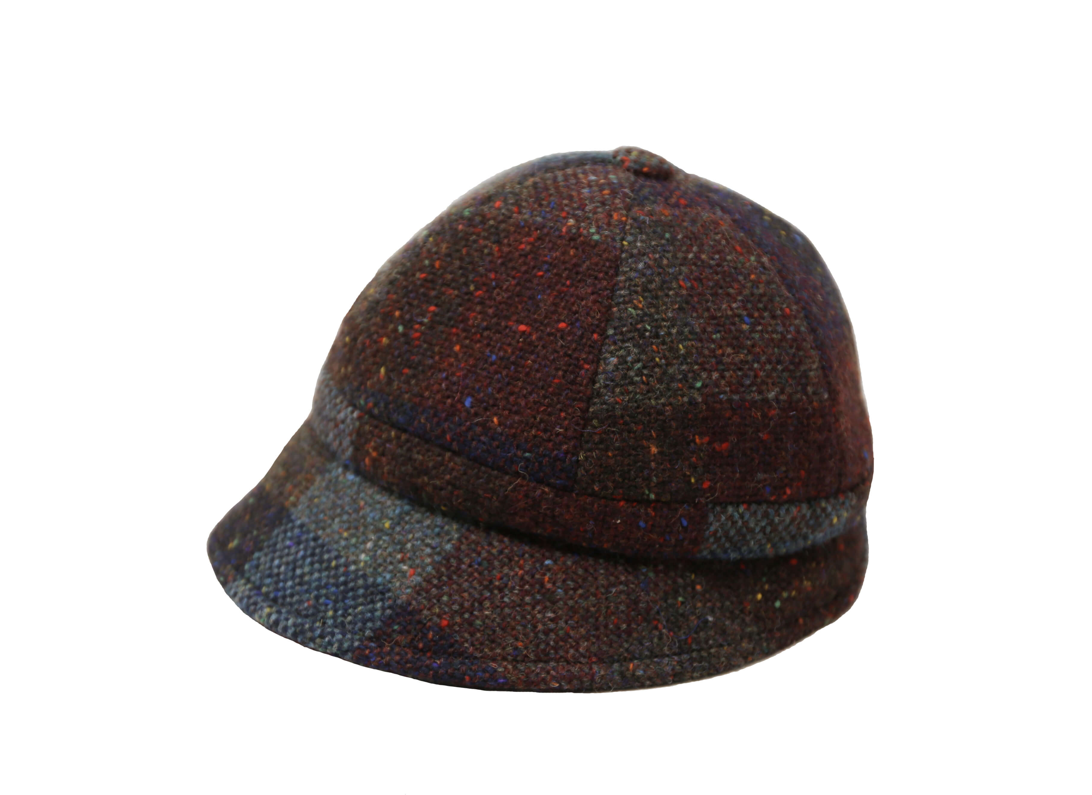 The Hanna Hats Slieve League Hat Tweed features a brown and blue patchwork tweed with multicolored speckles, a short brim, and is inspired by the rugged Donegal Coastline. Shown on a white background.