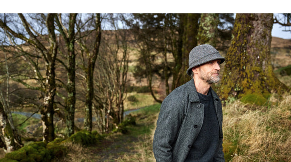 Finn wearing a Irish Tweed Grey Bucket Hat in a forest.