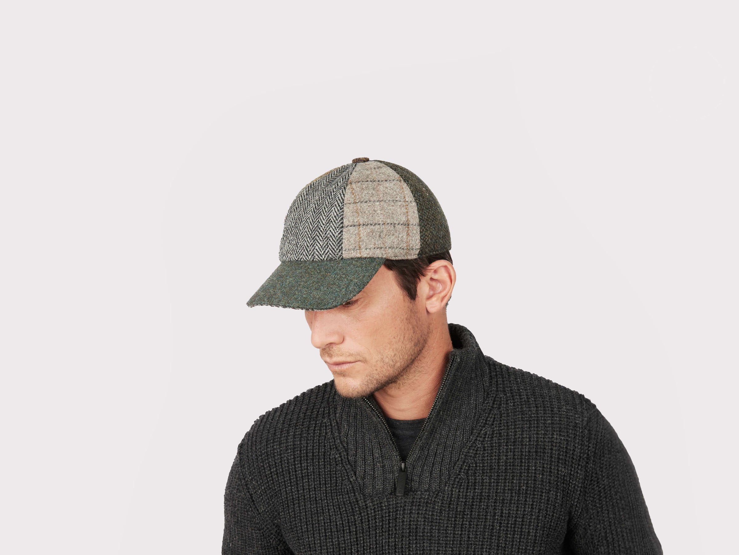 Adam wearing a Baseball Cap Patchwork Tweed with a grey wool sweater