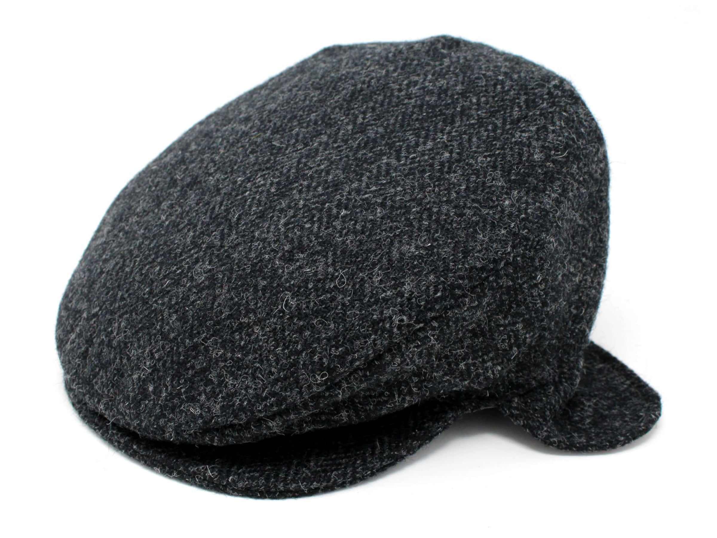 The Hanna Hats Vintage Cap Ear Flap Tweed is a dark gray Irish tweed cap with textured wool fabric and a classic flat cap design, displayed against a white background.