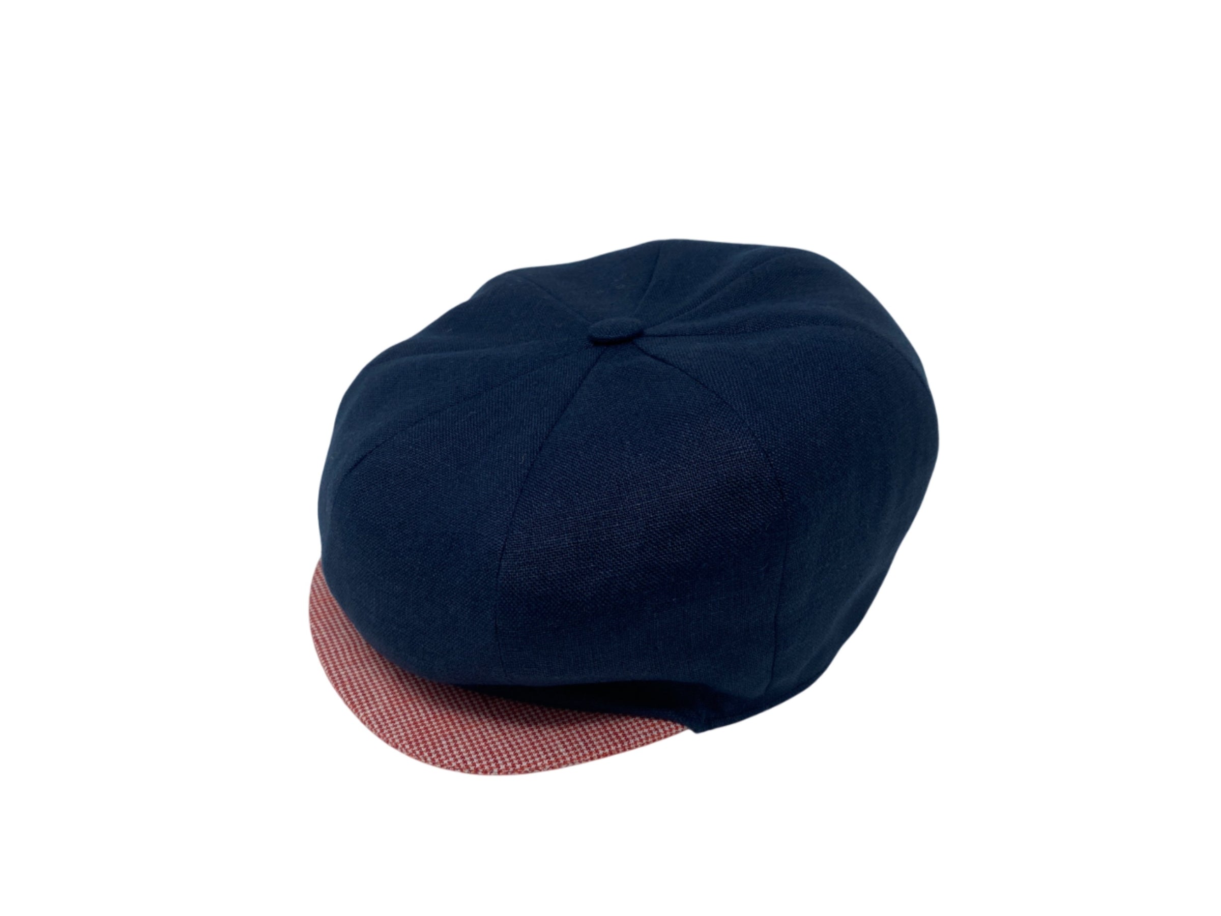 The Connery Cap 4th of July Limited Edition by Hanna Hats of Donegal Ltd features a dark blue round crown and a short, stiff, red-and-white checkered brim—perfect for Independence Day, shown on a white background.