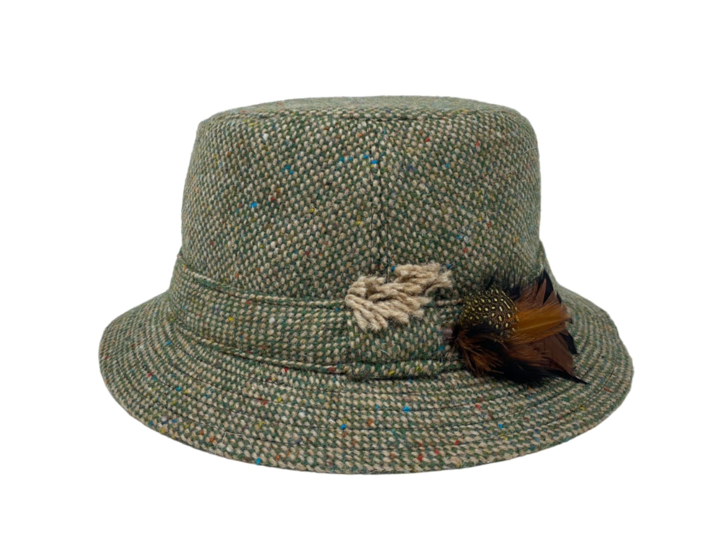 The Walking Hat Tweed by Hanna Hats is a green Irish tweed bucket hat inspired by the classic Irish Walking Hat, featuring a beige twisted rope detail and brown feather accent, shown on a plain white background.