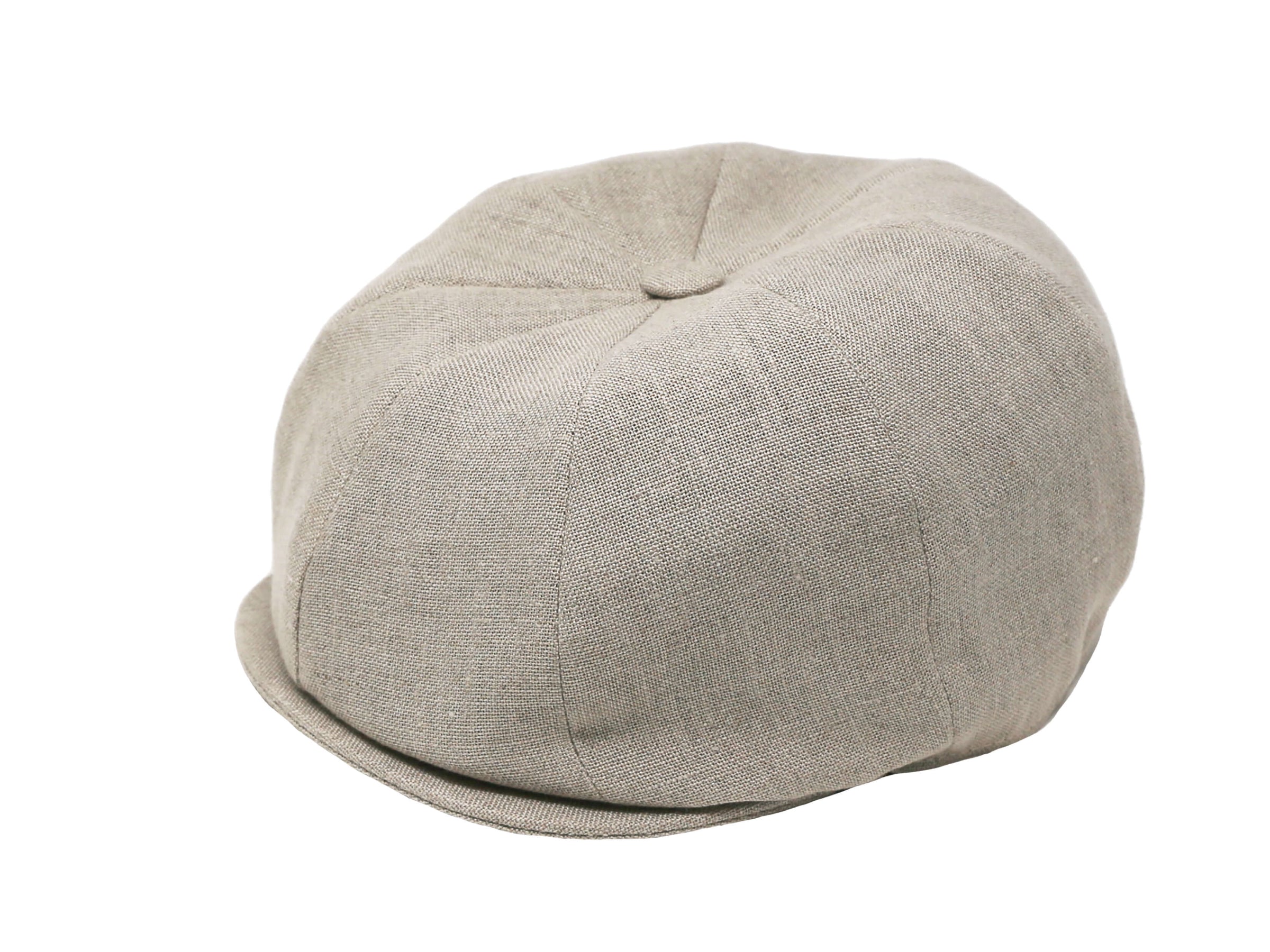 The Connery Cap Linen by Hanna Hats is a beige unisex cap made of textured fabric, featuring a round soft crown and small brim. Crafted from recycled plastic for an eco-friendly touch, it's shown on a white background.